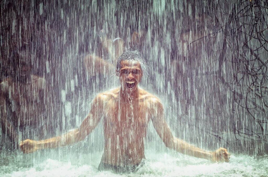 Raining on man under a waterfall