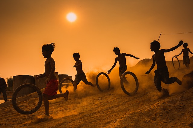 Children playing with tires at dusk