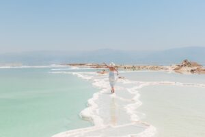 woman in white walking on the beach