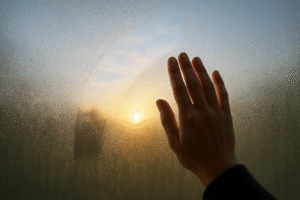 hand wiping a foggy window