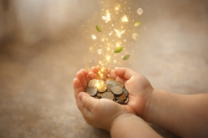 child's hand holding coins