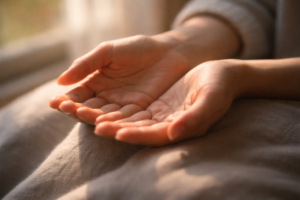 hands resting gently in soft sunlight