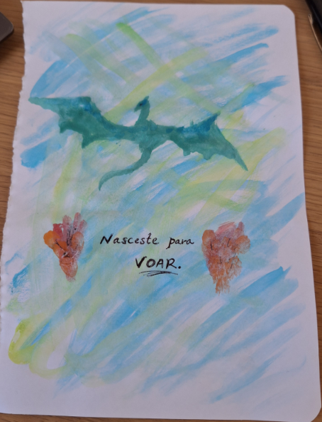 a drawing of a green dragon in a sheet of paper
