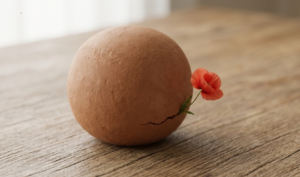 A minimalistic close-up of a matte terracotta sphere with a single red poppy growing from a small crack