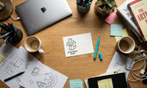 a cluttered desk with a note at the center